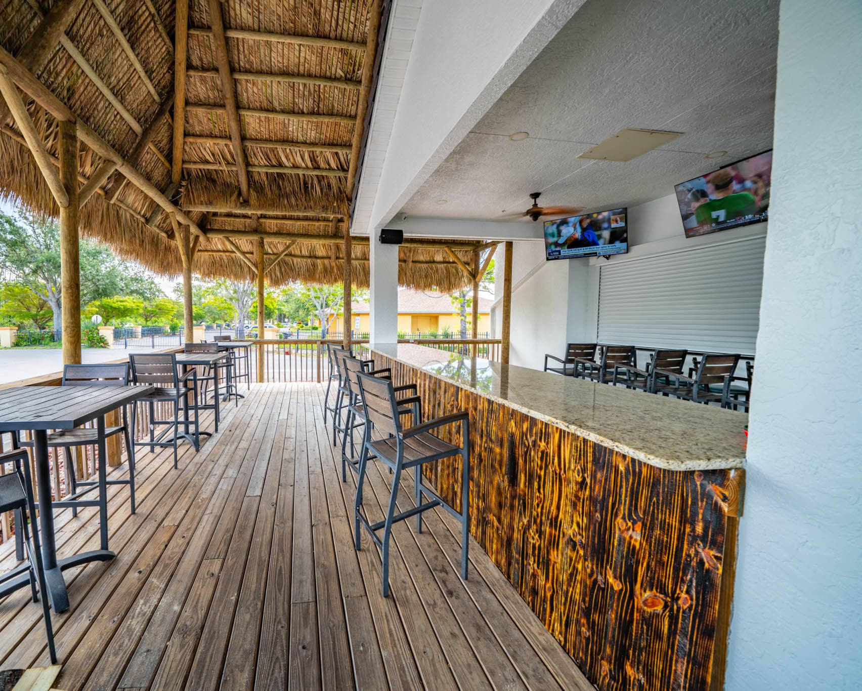 Tiki bar underneath a large tiki hut